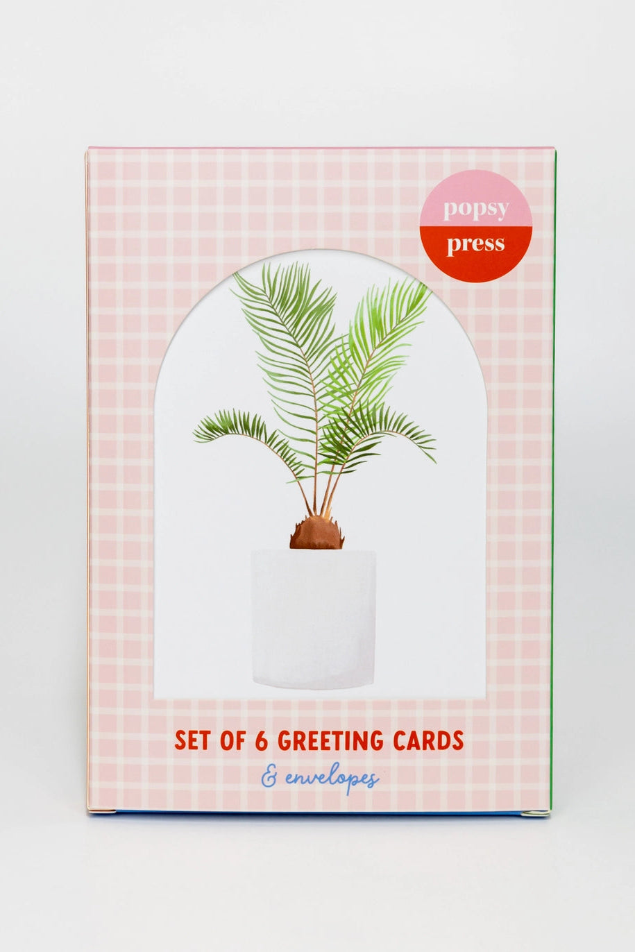 Packaging of a set of 6 greeting cards with a plant illustration on a pink checkered background.