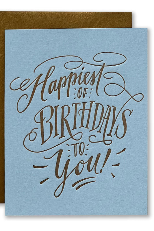 Blue birthday card with bronze text 'Happiest of Birthdays to You!' 