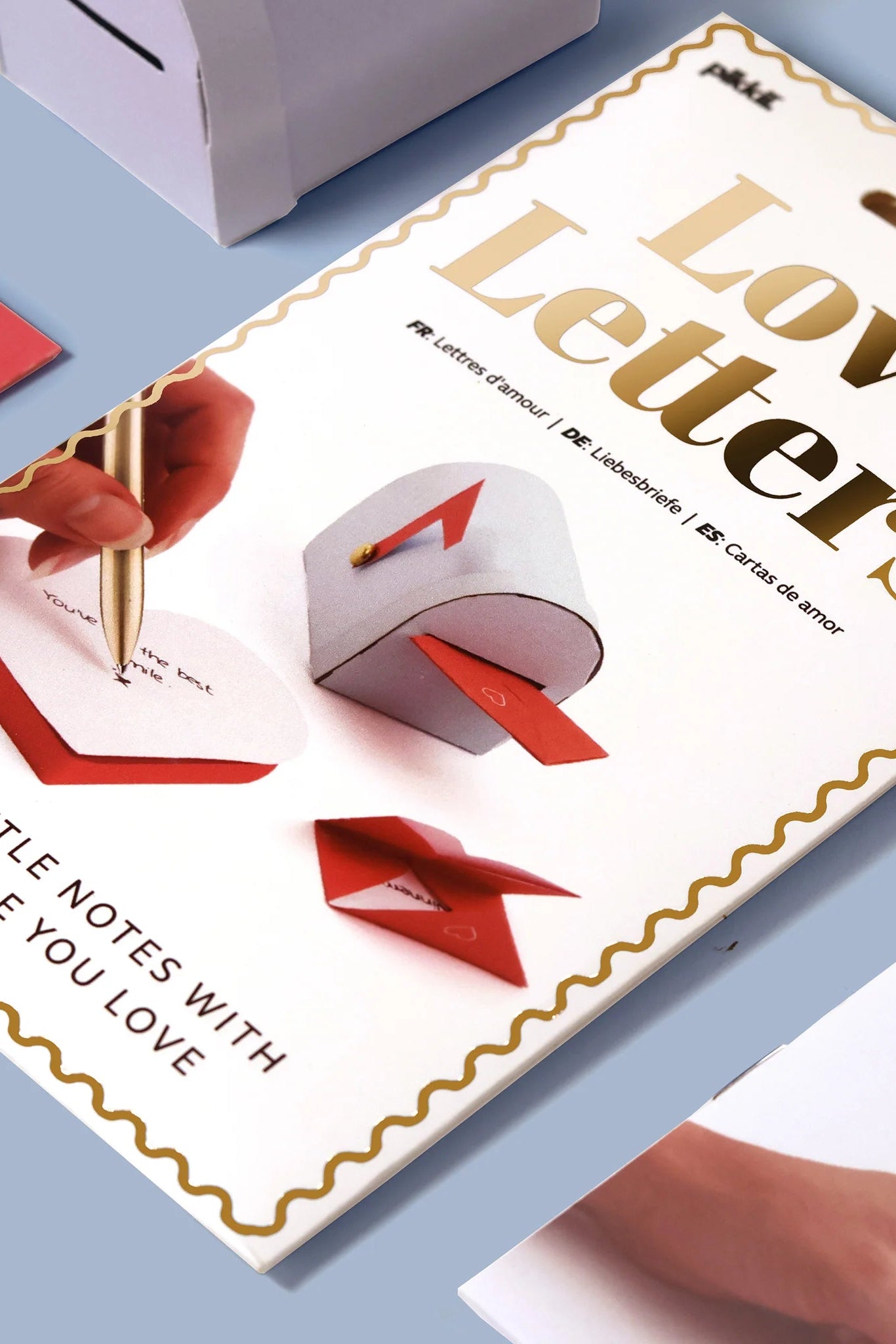 Product packaging for 'Love Letters' with a pen and envelope illustration on a blue background