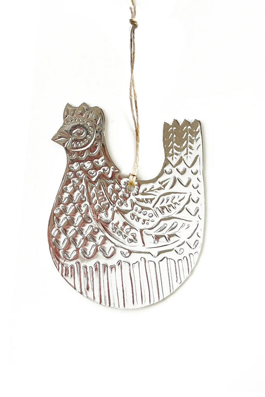Decorative metal rooster ornament on a white background