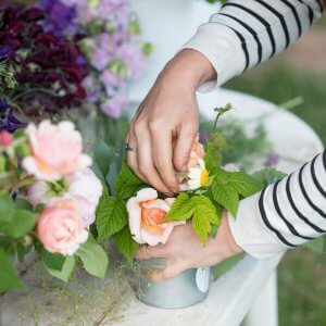 Hands making a beautiful flower arrangement with our locally grown flowers in Wagga Wagga.